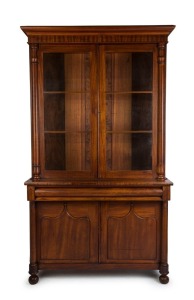 A Colonial Australian cedar bookcase with shield panel doors and turned columns, mid 19th century, 237cm high, 144cm wide, 54cm deep