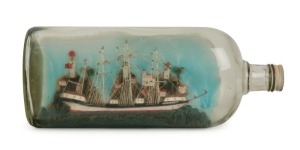 A vintage ship in a bottle titled "MELBOURNE", 27cm long