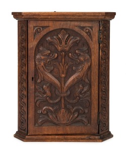A small antique corner cabinet with Germanic style carved griffin's heads, cedar and kauri pine, most likely South Australian origin, circa 1895, 40cm high, 31cm wide, 19cm deep