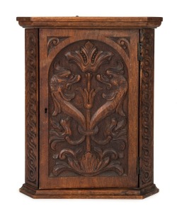 A small antique corner cabinet with Germanic style carved griffin's heads, cedar and kauri pine, most likely South Australian origin, circa 1895, ​​​​​​​40cm high, 31cm wide, 19cm deep