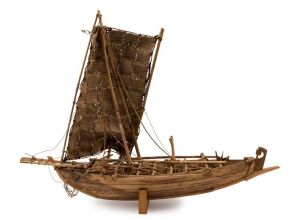 A model whaling boat, impressively scratch-built in timber and iron with woven fibre sail. Purchased from the Dili (Timor) whaling station in the 1960s, 47cm high, 63cm long