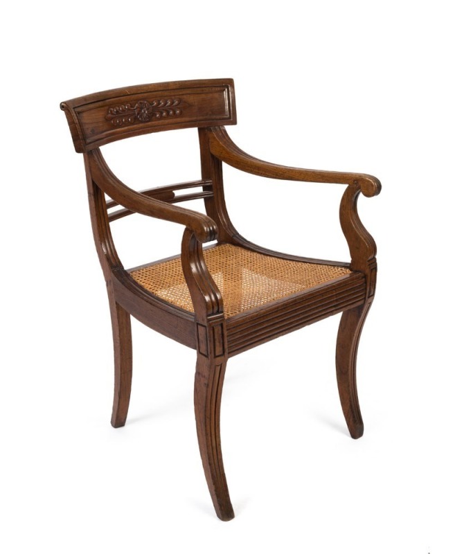 An antique cedar spade back armchair with rattan seat and sabre legs, early 19th century, ex Juliana and Toby Hooper collection 54cm across the arms