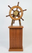 A ship's wheel and brass mount on later timber stand, early 20th century, ​​​​​​​the wheel 60cm wide, 141cm high overall - 2