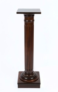 An antique Australian dark stained kauri pine pedestal with turned and fluted column, 19th/20th century, 111cm high, 31cm wide, 31cm deep