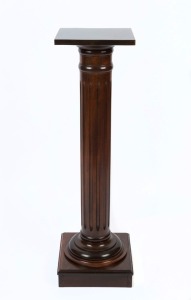 An antique Australian dark stained kauri pine pedestal with turned and fluted column, 19th/20th century, 111cm high, 31cm wide, 31cm deep