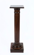 An antique Australian dark stained kauri pine pedestal with turned and fluted column, 19th/20th century, 111cm high, 31cm wide, 31cm deep