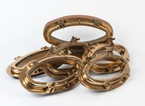 Set of six oval brass hinged portholes, 20th century, each 44cm wide