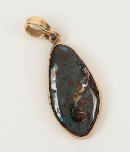 A polished boulder opal pendant mounted in 9ct yellow gold, 3cm high overall