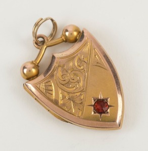 ARONSON & Co. of Melbourne, 9ct yellow gold shield shaped locket with red stone, stamped "9" flanked by pictorial marks, ​​​​​​​2.5cm high, 4.6 grams total