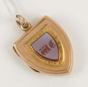 An antique 9ct yellow gold locket with engraved intaglio stone monogram shield, 19th century, ​​​​​​​2.5cm high, 7.2 grams total