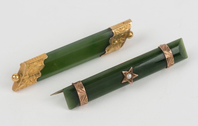 Two antique New Zealand greenstone bar brooches, both mounted in 9ct yellow gold, one set with a seed pearl in star, 19th century, ​​​​​​​5cm wide