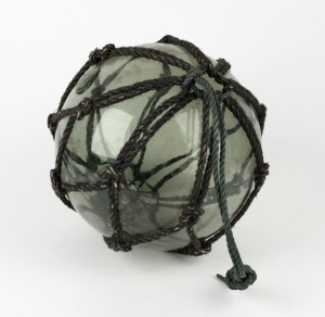 A vintage glass fishing buoy in rope netting, 28cm diameter