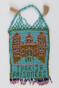 WW1 TURKISH P.O.W. beadwork bag emblazoned "TURKISH PRISONERS, 1917", adorned with an image of the prison.  A rare survivor in excellent condition, only the second example seen in our rooms. ​​​​​​​25cm high overall, 12cm wide