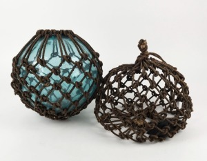 A glass fishing buoy with rope netting, together with a buoy netting only, (2 items), the glass example 32cm high