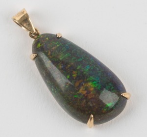 A solid black opal pendant set in 9ct yellow gold, 2cm high