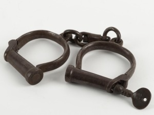 HIATT antique No.2 handcuffs, stamped "1915, M&C" (military and civilian) with broad arrow mark, with key, 24cm wide