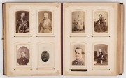 An old-time leather-bound photo album with hand-painted wooden front cover containing a range of cabinet-card and carte-de-visite size portraits; many Victorian photographers noted as well as two tintypes. (150+ images). - 2