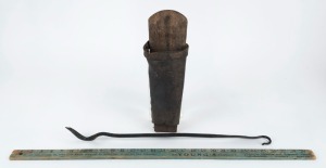 A primitive Australian butcher's scabbard made from cedar and leather, plus an iron pig fleshing tool, together with a "YOUNG'S" advertising yard rule, (3 items)