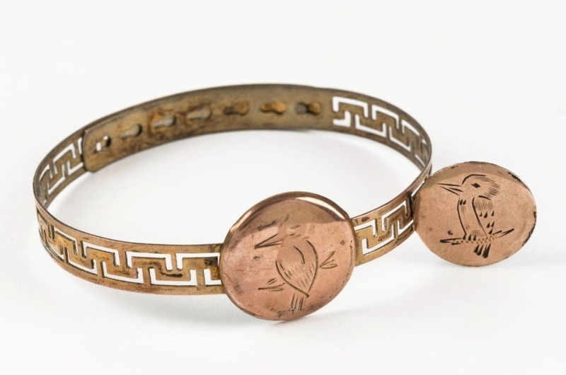 An antique adjustable gold plated bangle with kookaburra plaque, together with a matching brooch, circa 1900, (2 items), the brooch 2cm diameter