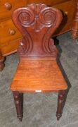 A Colonial cedar hall seat, scroll and acanthus leaf carved back rest with baluster and ring turned front legs, circa 1850. (after a design by Loudon 1833) ​​​​​​​86cm high, 39cm across the seat - 2