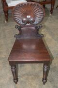 A pair of early Colonial Australian cedar hall chairs with finely carved shell backs and applied roundels, New South Wales origin, circa 1840, 87cm high. ​​​​​​​PROVENANCE: The Windeyer Family, New South Wales. - 2