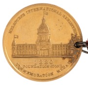 1880 MELBOURNE INTERNATIONAL EXHIBITION, Foundation Stone, commemoration medal in gold (22mm, 8.1g) by (E.Altmann), inscribed on reverse 'H. Creswick Esq. / Commissioner / 19/2/79'  with original button-hole ribbon with button. - 2