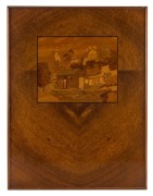 An Australian pictorial marquetry inlaid panel of a pioneers hut and figures in landscape, mounted in Queensland maple, 19th/20th century, 51 x 38.5cm overall