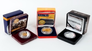 Coins - Australia: Decimal Proofs: $10 PROOFS: 2002 Adelaide Pound - gold plated; 2003 Sydney Mint Pattern - gold plated; 2013 Blue Mountains. (3 items).