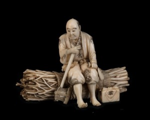 A Japanese carved ivory stature of the wood cutter, Meiji period, two character red seal mark to base, 7cm high, 10cm wide