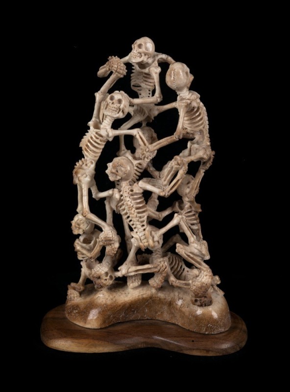 A carved antler skeleton figural group on wooden base, 20th century, 16cm high overall