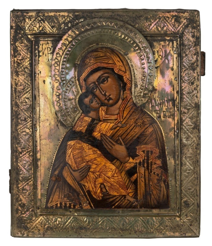 A Russian orthodox icon depicting the Mother of God of Vladimir, hand-painted in pressed metal frame, 19th century, 31.5cm x 27cm 