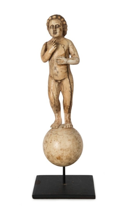 An antique Goanese carved ivory figure of baby Jesus south Indian origin, 17th/18th century,  19cm high, 22cm overall