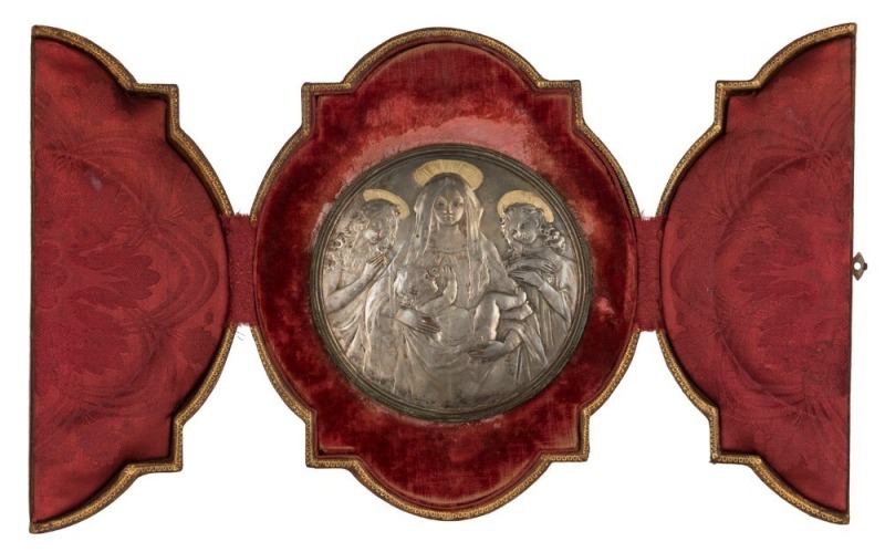 An art-nouveau medallion in in silvered copper depicting the Madonna and Child and attendant angels, in original tooled leather and damask case, signed at base by Luca Madrassi (1848-1919), 19th century, 21cm high overall