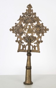 An Ethiopian Orthodox processional cross adorned with the Virgin Mother and Child surrounded by angels, bronze and silvered finish, 19th/20th century, 31.5cm high