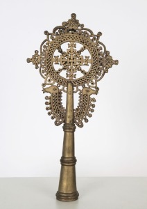 An Ethiopian Orthodox processional cross adorned with camel head decoration, bronze with remains of silver finish, 19th/20th century, 30.5cm high