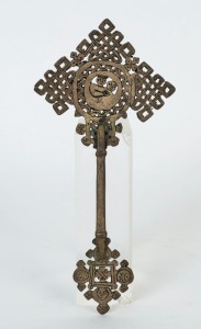 An Ethiopian Orthodox handheld crucifix adorned with the Virgin Mother and Child, bronze with remains of silver finish, 19th/20th century, 25.5cm high