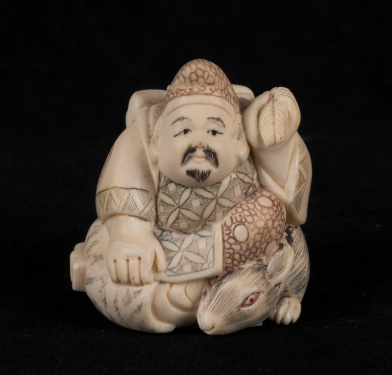 A Japanese carved ivory statue of a man and a rat, Meiji period, seal mark to base, 5cm high