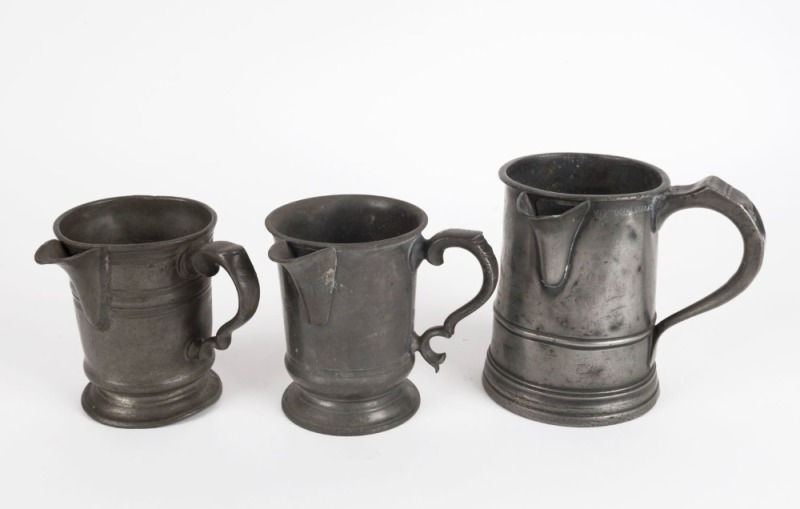 Three assorted antique pewter jugs comprising an Imperial quart and two pints, 18th and 19th century, the largest 15cm high