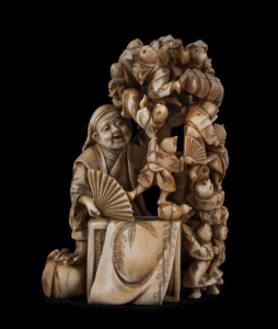 A Japanese carved ivory netsuke figural group of the climbing boys, Meiji period, red seal mark to base, 7.5cm high, 5.5cm wide