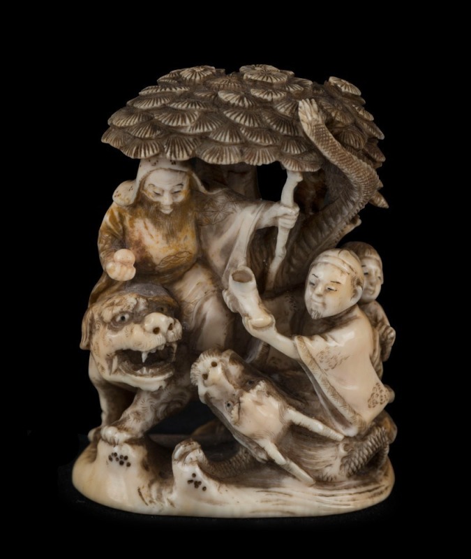 A Japanese carved ivory netsuke figural group with tree, serpent, dragon, figures and lion, Meiji period, ​​​​​​​two character mark to base, 6.5cm high