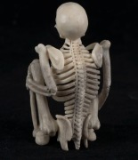 A carved antler statue of a squatting skeleton figure, 20th century, 8cm high  - 3