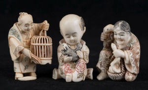 Three Japanese carved ivory netsuke with hand-painted finish, comprising a boy with a rat, a man with a birdcage, and a lady with animals, Meiji period, 20th century, the largest 5.5cm high