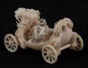 A Japanese carved ivory netsuke dragon cart with seated figures, Meiji period, 20th century, 5.5cm long - 2