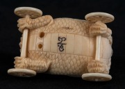 A Japanese carved ivory netsuke dragon cart with seated figures, Meiji period, 20th century, 5.5cm long - 3