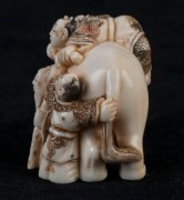 A Japanese carved ivory and hand-coloured netsuke of an elephant and figures, Meiji period, 20th century, ​​​​​​​4cm high - 3