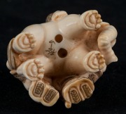 A Japanese carved ivory and hand-coloured netsuke of an elephant and figures, Meiji period, 20th century, ​​​​​​​4cm high - 4