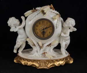 MOORE BROTHERS English porcelain cased mantle clock adorned with cherubs and cactus, time piece only, 19th century, 23cm high