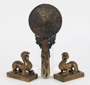 A pair of Chinese cast bronze mythical guardian statues, together with a jade and bronze hand mirror,19th and 20th century, ​​​​​​​the mirror 23cm long