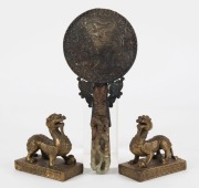 A pair of Chinese cast bronze mythical guardian statues, together with a jade and bronze hand mirror,19th and 20th century, ​​​​​​​the mirror 23cm long