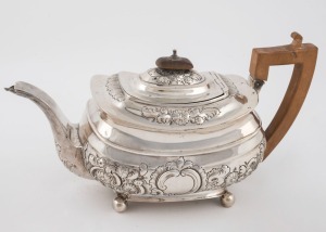 A Georgian sterling silver teapot with engraved and repousse decoration, made in London, circa 1807, 16cm high, 28cm wide, 588 grams total